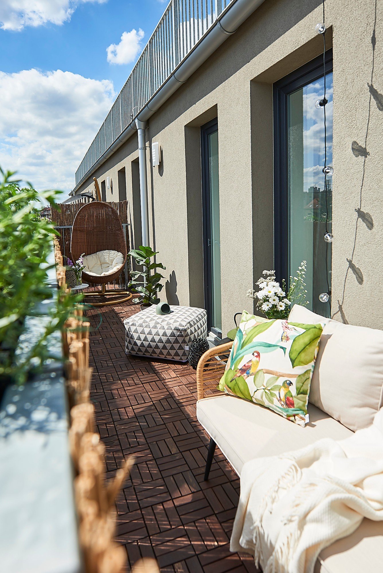 Na dlouhém úzkém balkoně funguje nábytek podél stěny – zůstane tak volný průchod a prostor bude působit větší.